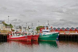 Fishing boats docked in colorful Killybegs Harbor in Co. Donegal.
