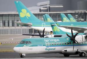 Aer Lingus planes are shown at Dublin airport, Ireland, on Tuesday, Jan. 27, 2015. Aer Lingus said it supports a takeover bid by British Airways parent IAG, putting the Irish national airline with its trademark shamrock tailfins on course for foreign acquisition nine years after its privatization. AP Photo/Peter Morrison